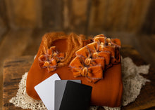 limited-edition "rust" bow OR wrap OR backdrop ($18/20/16/42)